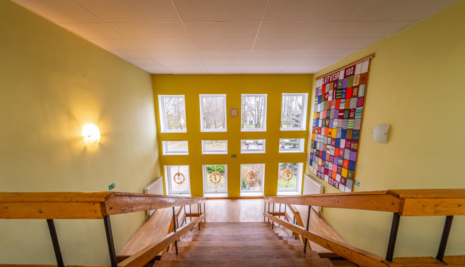 Iekštelpu kāpnes, kas ved uzleju pretī lielam logam